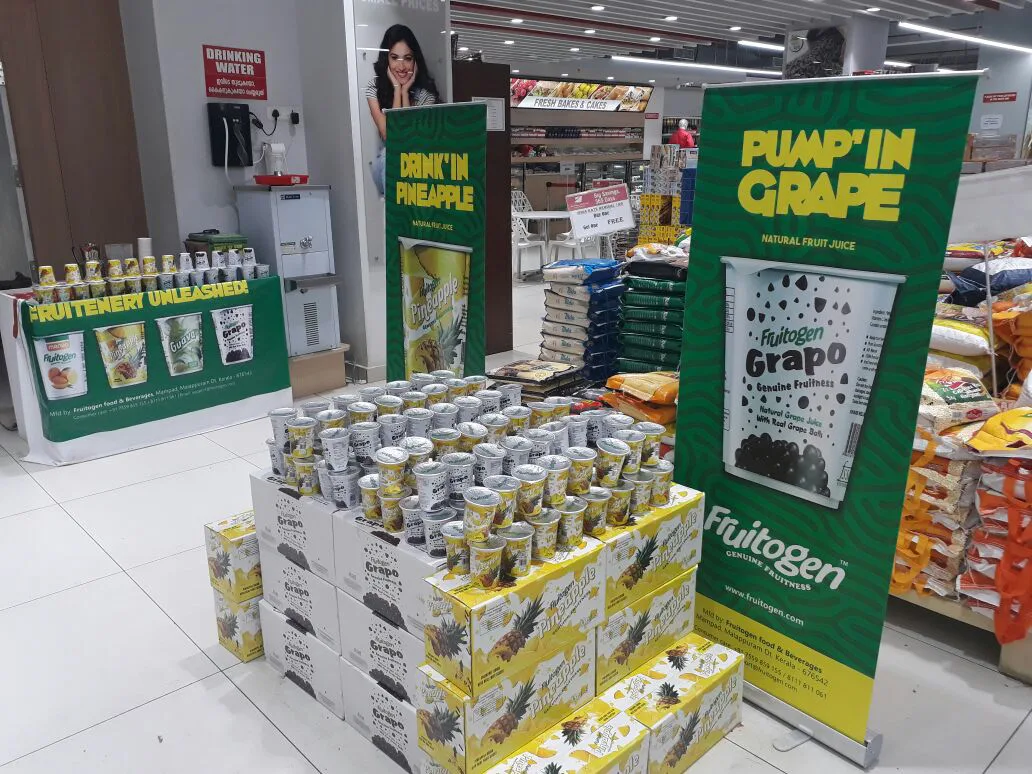 Fruitogen Pineapple and Grapo display stacked at a retail store